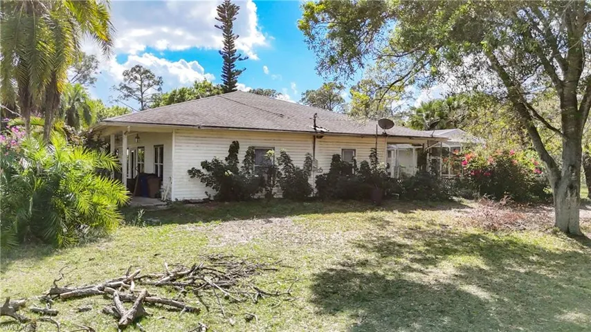 Rear view of house featuring a yard