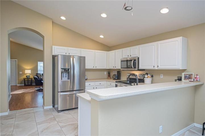 Bright, open kitchen with Corian countertops and new stainless appliances!
