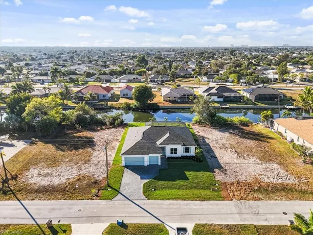 Aerial view of residential area featuring a nearby body of water