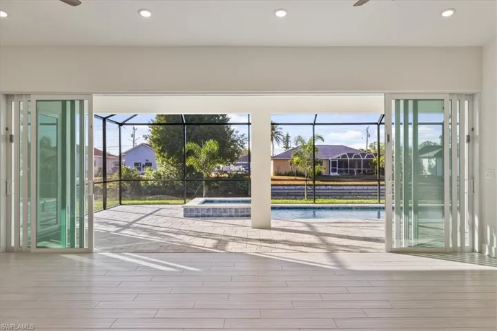 Doorway with a ceiling fan, recessed lighting, plenty of natural light, and a sunroom