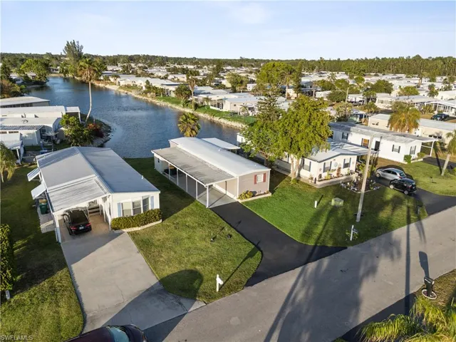 Aerial view of residential area featuring a nearby body of water