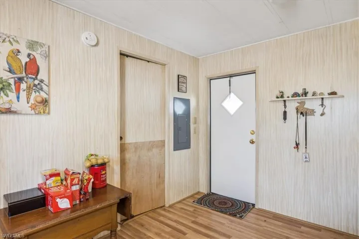Entryway with wood finished floors and electric panel