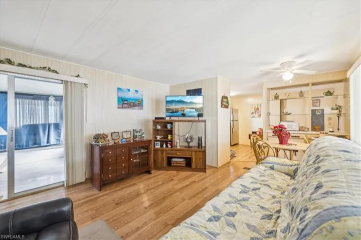 Living room with wood finished floors and ceiling fan