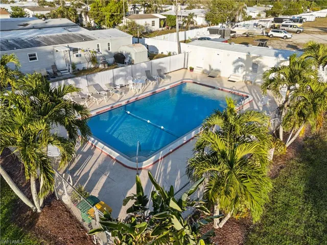 Community pool featuring a fenced backyard and a patio