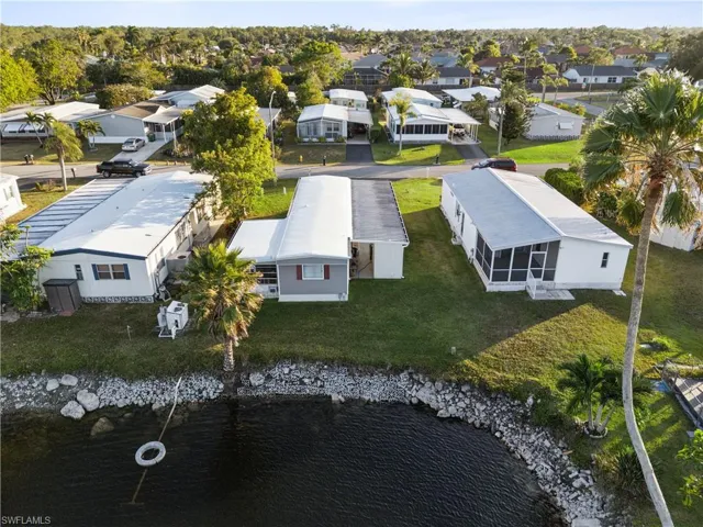 Aerial perspective of suburban area featuring a nearby body of water