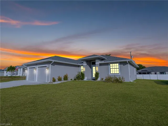 Prairie-style house with stucco siding, a garage, and concrete driveway