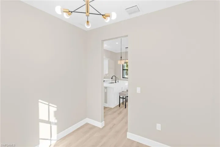 Den/Office featuring a chandelier and light wood-style floors