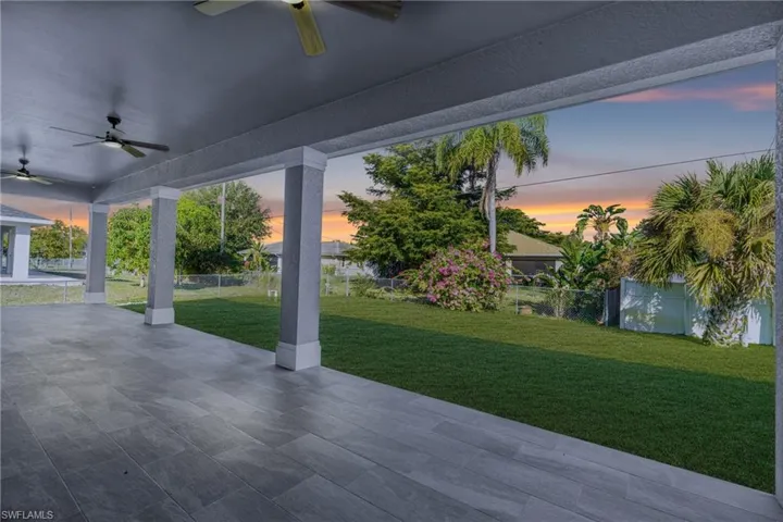 Patio terrace at dusk featuring ceiling fan, a patio, and a fenced backyard