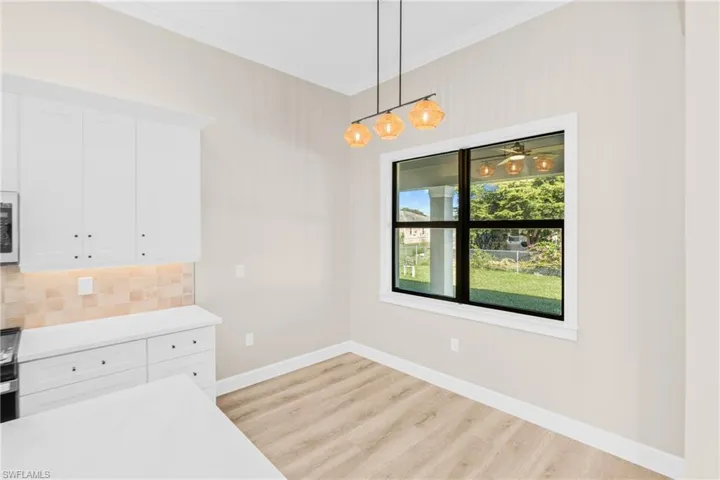 Unfurnished dining area featuring ornamental molding and light wood finished floors