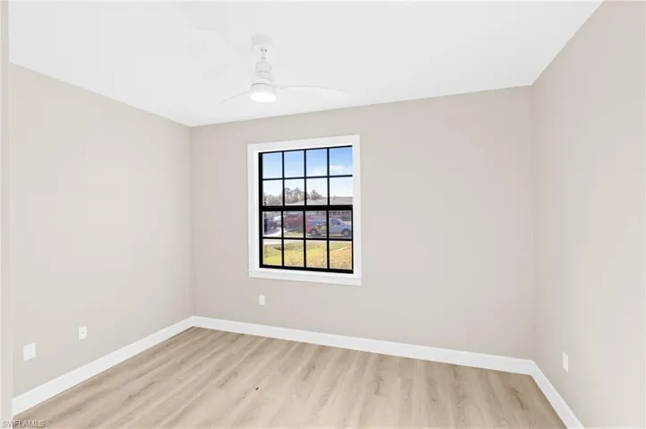 Den with a ceiling fan and light wood-style floors