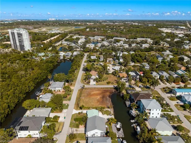 Aerial overview of property's location with nearby suburban area and a large body of water