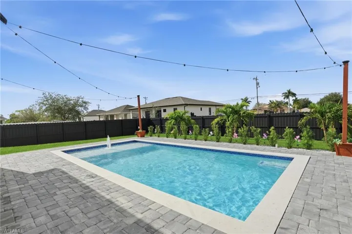 View of pool with a fenced backyard and a patio