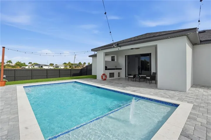 View of swimming pool featuring a patio area and a fenced backyard