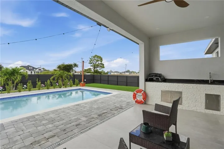 View of pool with a patio area and a fenced backyard
