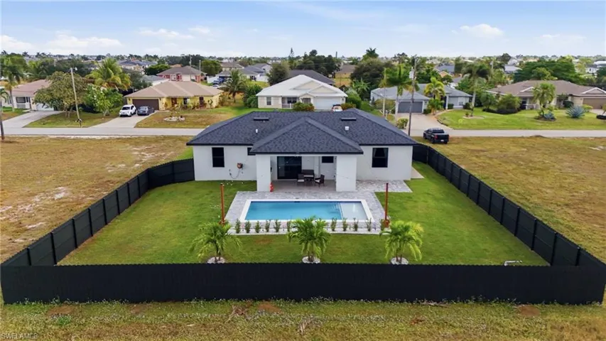 Back of house featuring a residential view, a patio area, stucco siding, and a fenced backyard