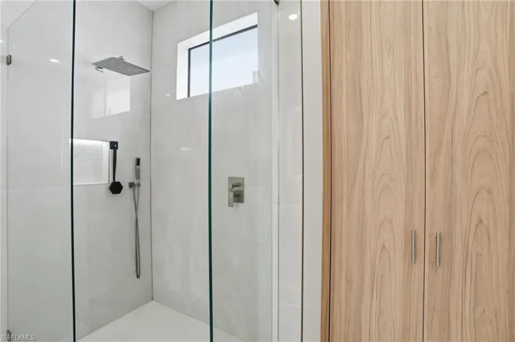 Full bath featuring a shower stall