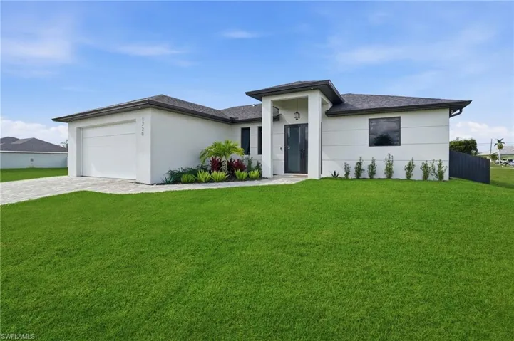 Prairie-style home with decorative driveway, a garage, roof with shingles, and stucco siding