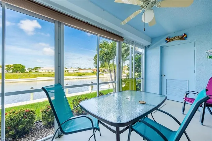 Sunroom / solarium with a water view and ceiling fan