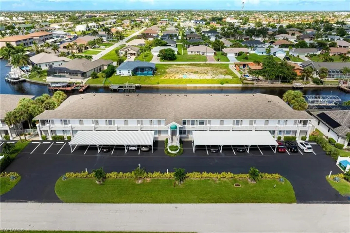 Birds eye view of property with a water view