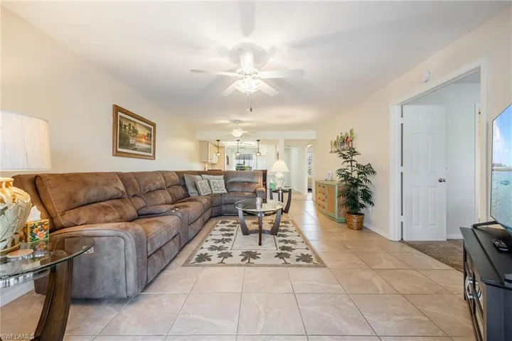 Living room with tile  ceiling fan, and a wealth of natural light