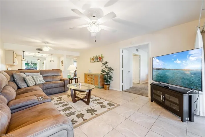 Tiled living room featuring ceiling fan