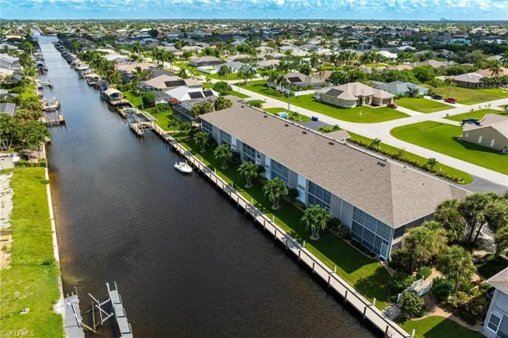 Birds eye view of property with a water view