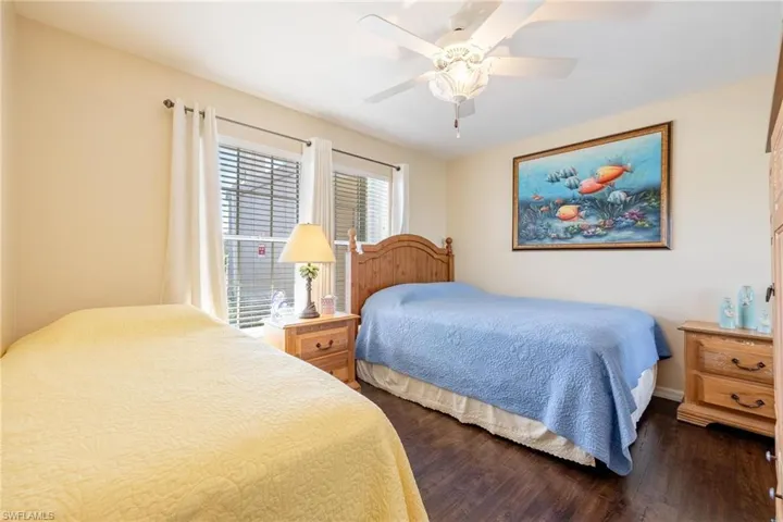 Bedroom featuring ceiling fan and dark hardwood / wood-style flooring