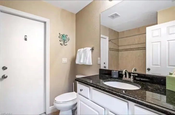 Bathroom featuring vanity and toilet