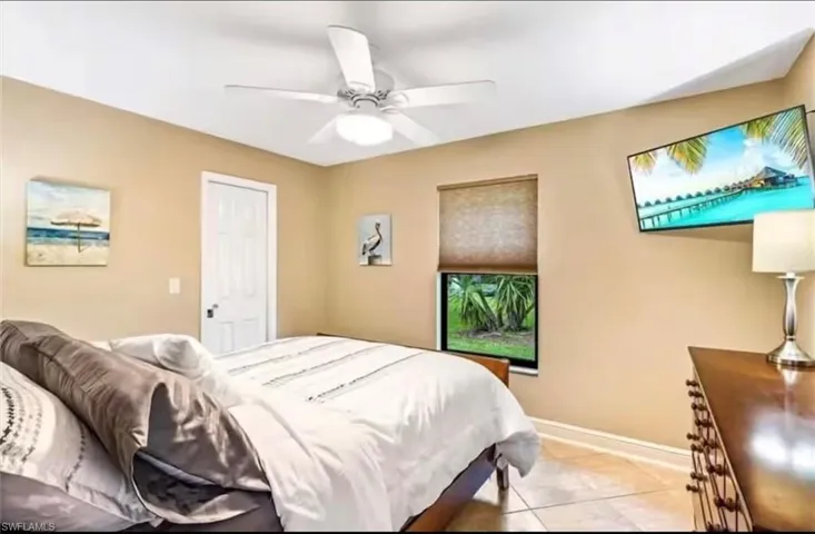 Tiled bedroom with ceiling fan