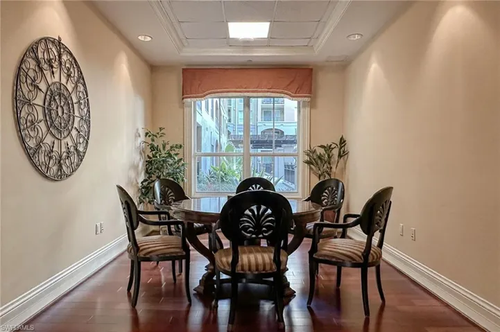 Dining space featuring a tray ceiling and dark hardwood / wood-style flooring