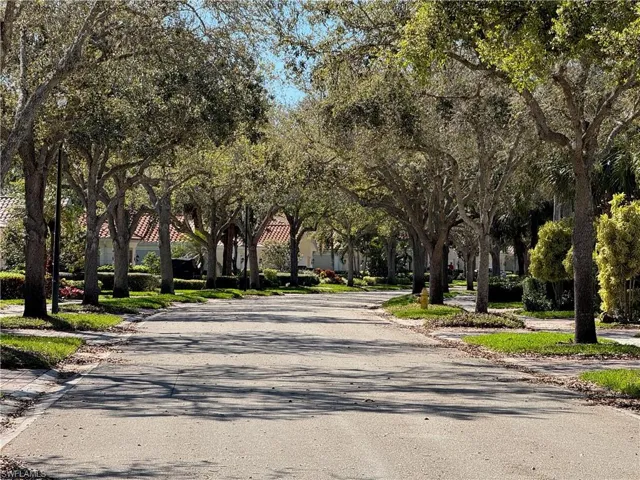 Picturesque Oak tree-lined streets with lush landscaping and charming neighborhood appeal throughout IslandWalk.
