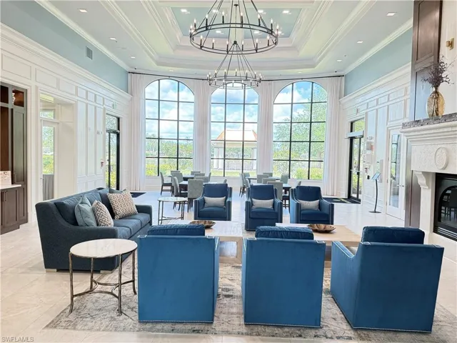 Stunning Town Center clubhouse with soaring ceilings, elegant seating areas, fireplace, and abundant natural light.