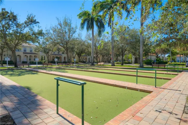 Community bocce courts surrounded by lush tropical landscaping and inviting outdoor gathering spaces.