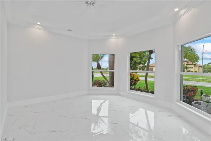 This impressive entrance sets the tone—modern elegance meets solid construction in this hurricane-safe masterpiece.