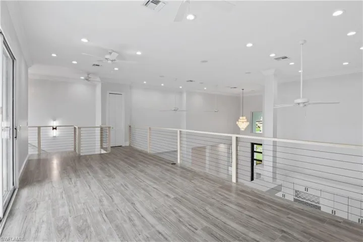 Versatile and full of natural light, the upstairs loft includes its own half bath and opens to a balcony with sweeping views of the water—perfect as a home office, studio, or media space.