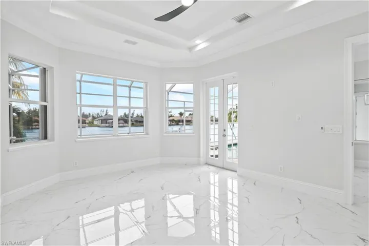 Your private retreat awaits. Located on the first floor, this luxurious master suite features his and hers walk-in closets, water views, and easy access to the pool.