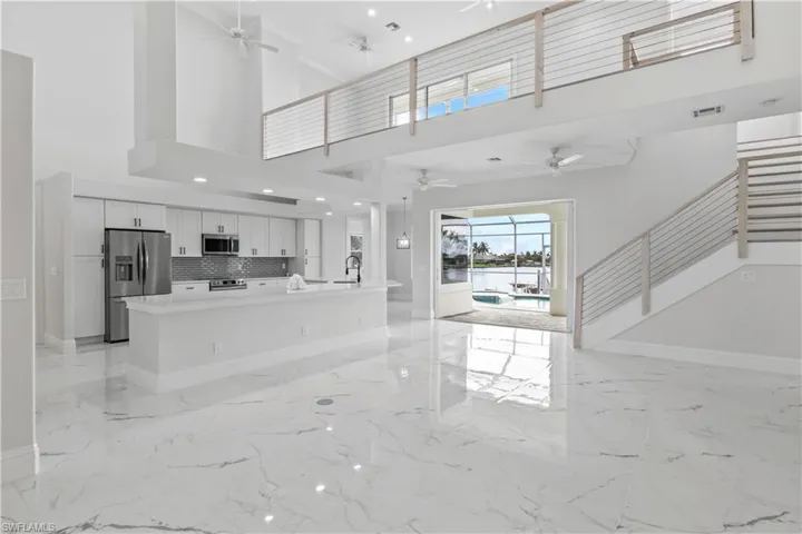 Enjoy open-concept living with high ceilings, modern finishes, and stunning views of the water just beyond.