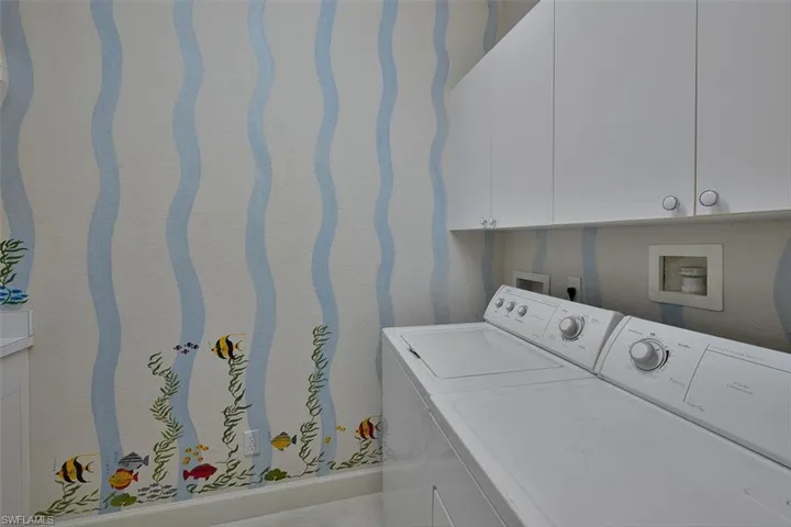 Laundry room has full size washer and dryer, extra cabinetry and a spash of fun!