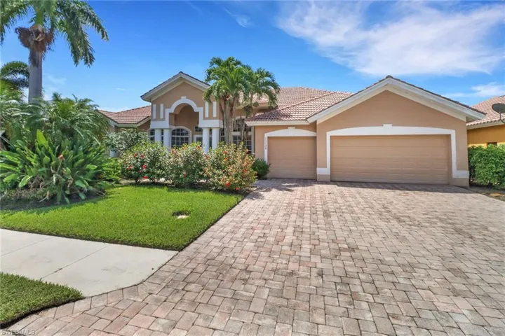 Front of home with paver driveway
