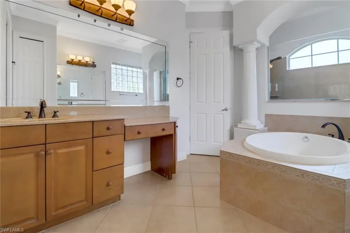 Main bathroom with relaxing soaking tub, vanity with make-up area & private water closet