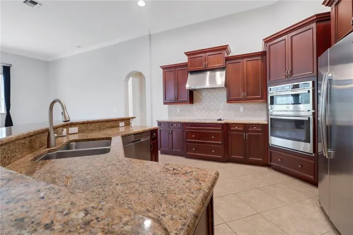 Kitchen featuring ample counter prep space & stainless steel appliances