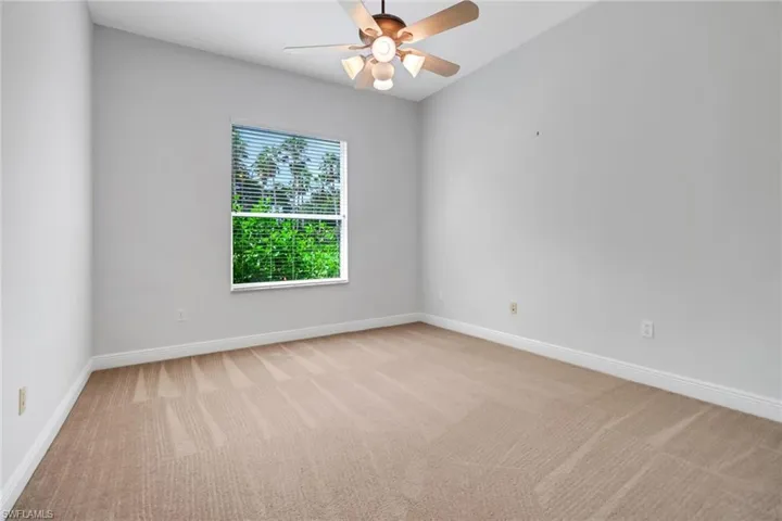 Guest bedroom with view of backyard