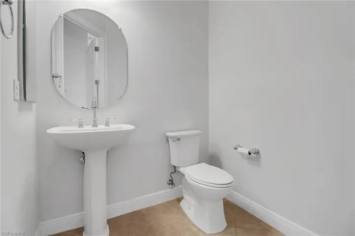 Powder room conveniently located near the living room / kitchen area