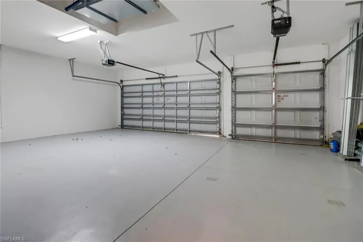 Three car garage with a automatic garage door openers & access door to side yard