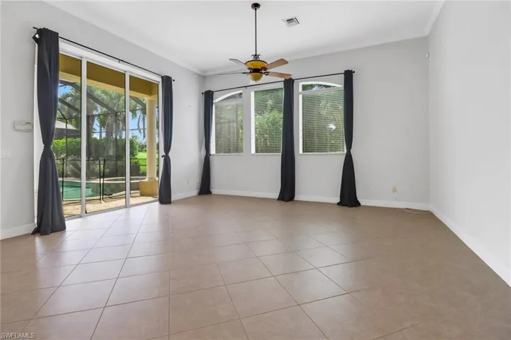 Spacious family room with sliding glass door leading to lanai & views of golf course