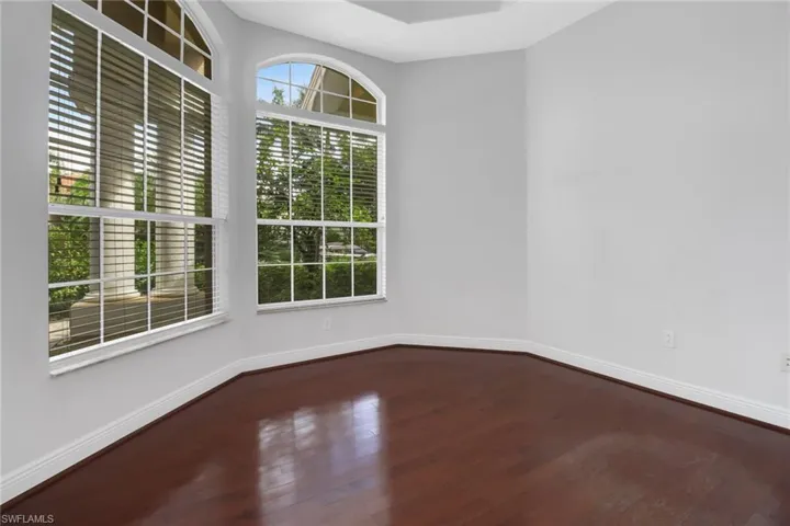 Den / office with an abundance of natural light & hardwood flooring