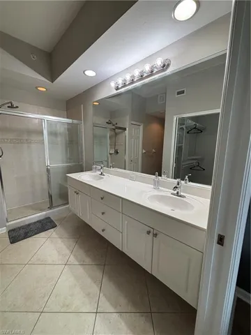Dual vanity with undermount sinks, a spacious countertop, and ample storage cabinetry