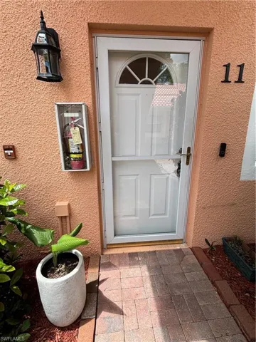 View of exterior entry with stucco siding