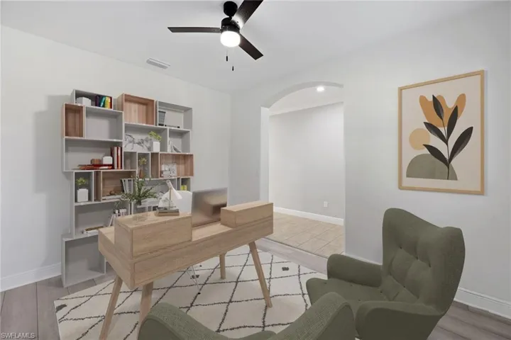 Virtually staged Office space with ceiling fan and light wood-type flooring