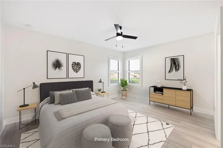 Virtually Staged Master suite with light wood-type flooring and ceiling fan